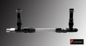 Flexible metal hose with black connectors on a gray background.