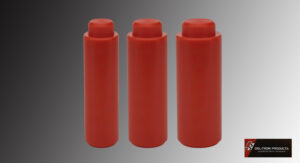 Three red cylindrical containers with caps against a gray background.