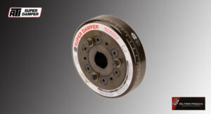 Close-up of a metal damper with engraved markings on a gray background.