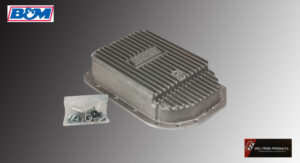 Metal oil pan with mounting hardware on a gray background.