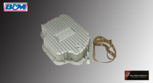 Metal automotive part with a gasket beside it on a gradient background.