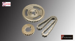 A metal sprocket set with a chain on a gray background.