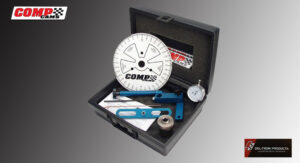 A precision measuring tool kit with dial gauge and blue calipers in a black case.