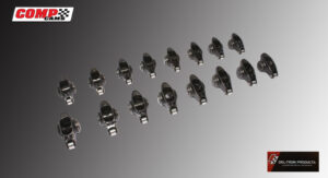 A set of metallic hinge components arranged on a gray surface.