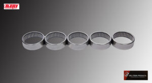 A row of five metal circular objects with vertical slots on a reflective surface.