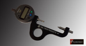 Close-up of a digital depth gauge tool against a gradient background.