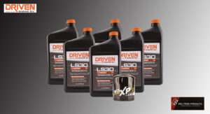 Bottles and a container of Driven LS30 lubricant products with orange caps.