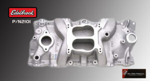 Silver metal engine intake manifold with multiple ports and mounting holes.