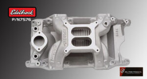 Silver automotive intake manifold with visible ports and mounting points.