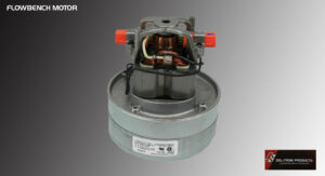 Electric motor component with wiring and label on a gray background.