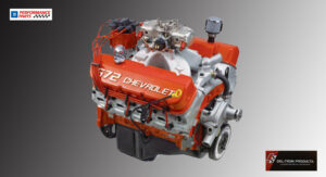 A bright orange Chevrolet 427 V8 engine with chrome components.
