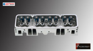 Close-up of a metallic engine cylinder head with valve springs and ports.