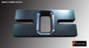 Close-up of a black metal bracket with a rectangular cutout and two elongated holes.