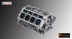 Metal engine block with six cylinders displayed against a gray background.