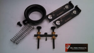 Various mechanical parts including springs, screws, and metal brackets arranged on a surface.