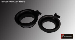 Two black circular objects with small protrusions on a gray surface.