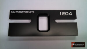 Close-up of a black I20 panel with rectangular cutouts and text markings.