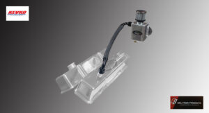 Industrial robotic arm inspecting a transparent engine block.