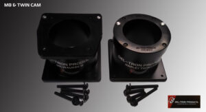 Two black metal speaker tweeters with screws on a surface.