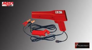 Vintage red electric branding iron with clamps and cord.