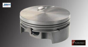 Close-up of a metal engine piston with rings and grooves.