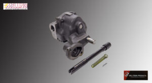 A mechanical component with a shaft, spring, and metal rod on a gray background.