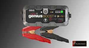 Battery charger clamps with red and black grips on a Genius Boost device.