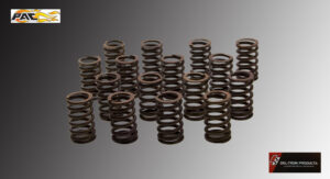 A collection of rusty metal coil springs arranged on a gray surface.
