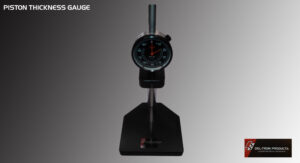 Precision dial gauge measuring tool on a black stand.