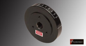 Black mechanical dial or knob with numeric markings and a red label.