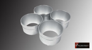 Four metallic cylindrical containers with smooth interiors.
