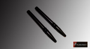 Two black tactical pens with pointed tips on a gray surface.