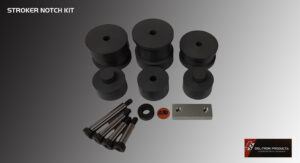 Set of black metal spacers and mounting hardware on a gray surface.