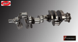 A close-up of a metallic crankshaft against a gradient background.