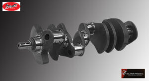 Close-up of a metallic crankshaft component against a grey background.