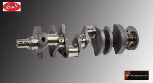 A detailed view of a metal crankshaft with multiple connecting rods.