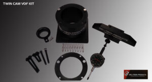 Disassembled mechanical gauge parts on a dark surface.