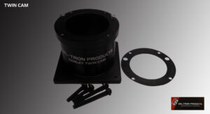 Black metal flange with screws and gasket on a gray surface.