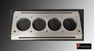Metal panel with four large circular holes and smaller bolt holes.