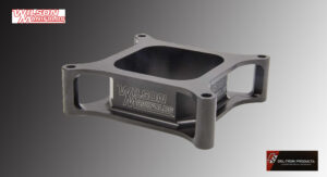 Close-up of a precision-machined metal component with engraved text.