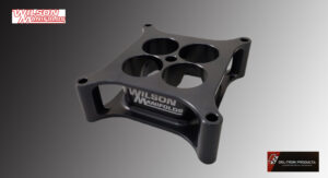 Black Wilson Performance aluminum component with multiple circular cutouts.
