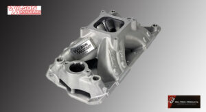Metal automotive intake manifold with smooth, complex casting and polished surfaces.